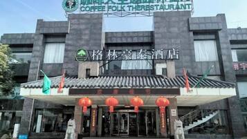 A building with a sign for a coffee folk restaurant and a traditional Chinese architectural style.