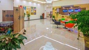 A hotel lobby with a reception desk, modern chairs, a chandelier, and a polished floor. - GreenTree Inn Anshun Xihang Road Hotel (Anshun)