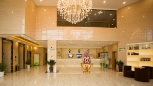 A spacious lobby with a reception desk, a chandelier, and a sign for Green Tree Inn. - GreenTree Inn HuaiAn KangJian W Road XiAn Road Hotel (Huai'an)
