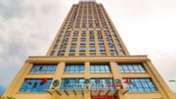 A tall, modern building with a symmetrical facade, large windows, and a central entrance.