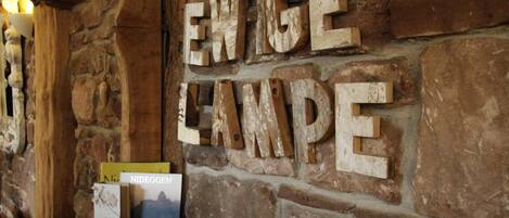A stone wall with the words "ENWIGELANPE" carved into it.