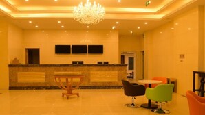 A hotel lobby with a reception desk, a chandelier, and several chairs. - GreenTree AnHui Wuhu Sanshan Development District Express Hotel (Wuhu)