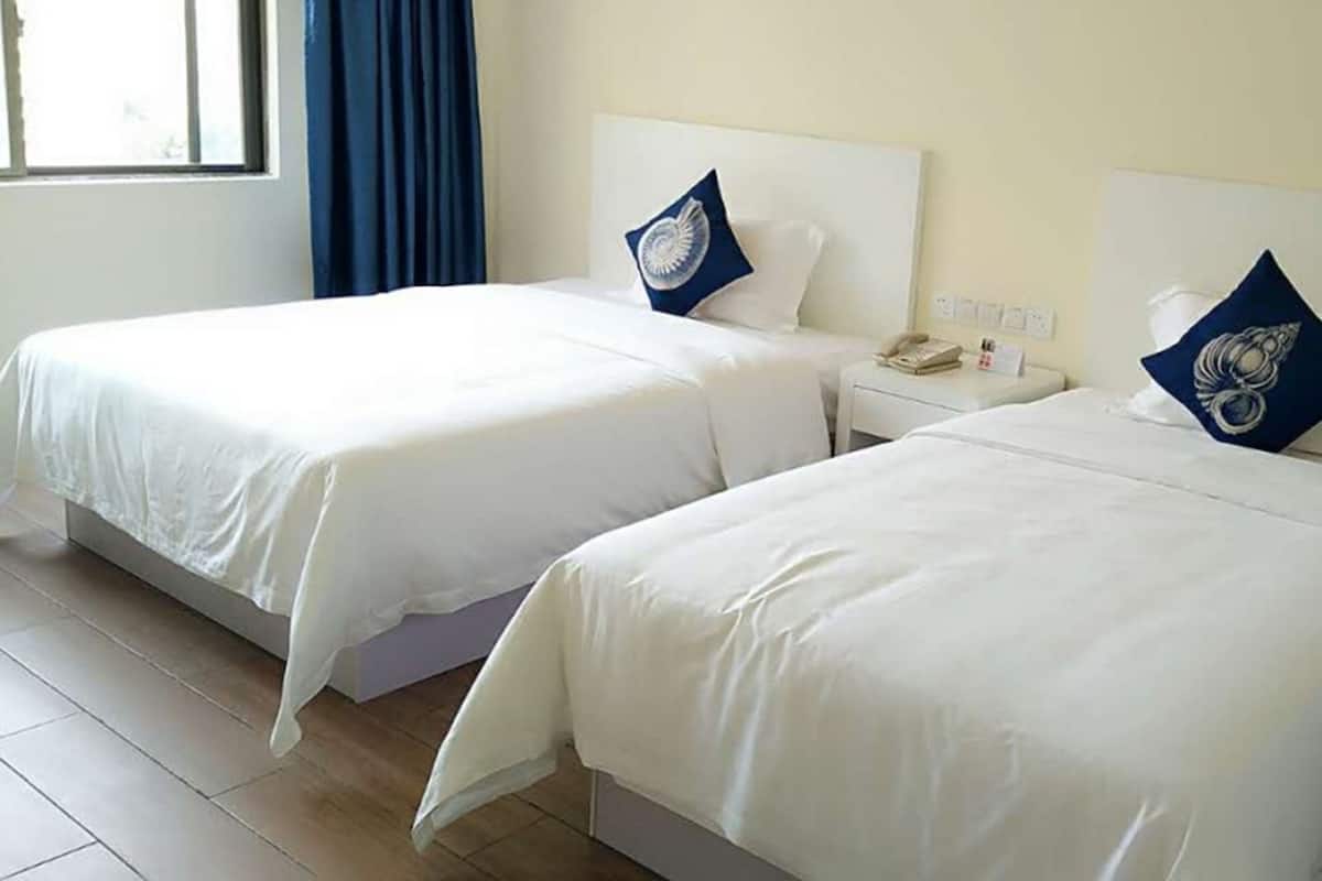Chambre Deluxe avec lits jumeaux | Rideaux occultants, fer et planche à repasser, Wi-Fi gratuit