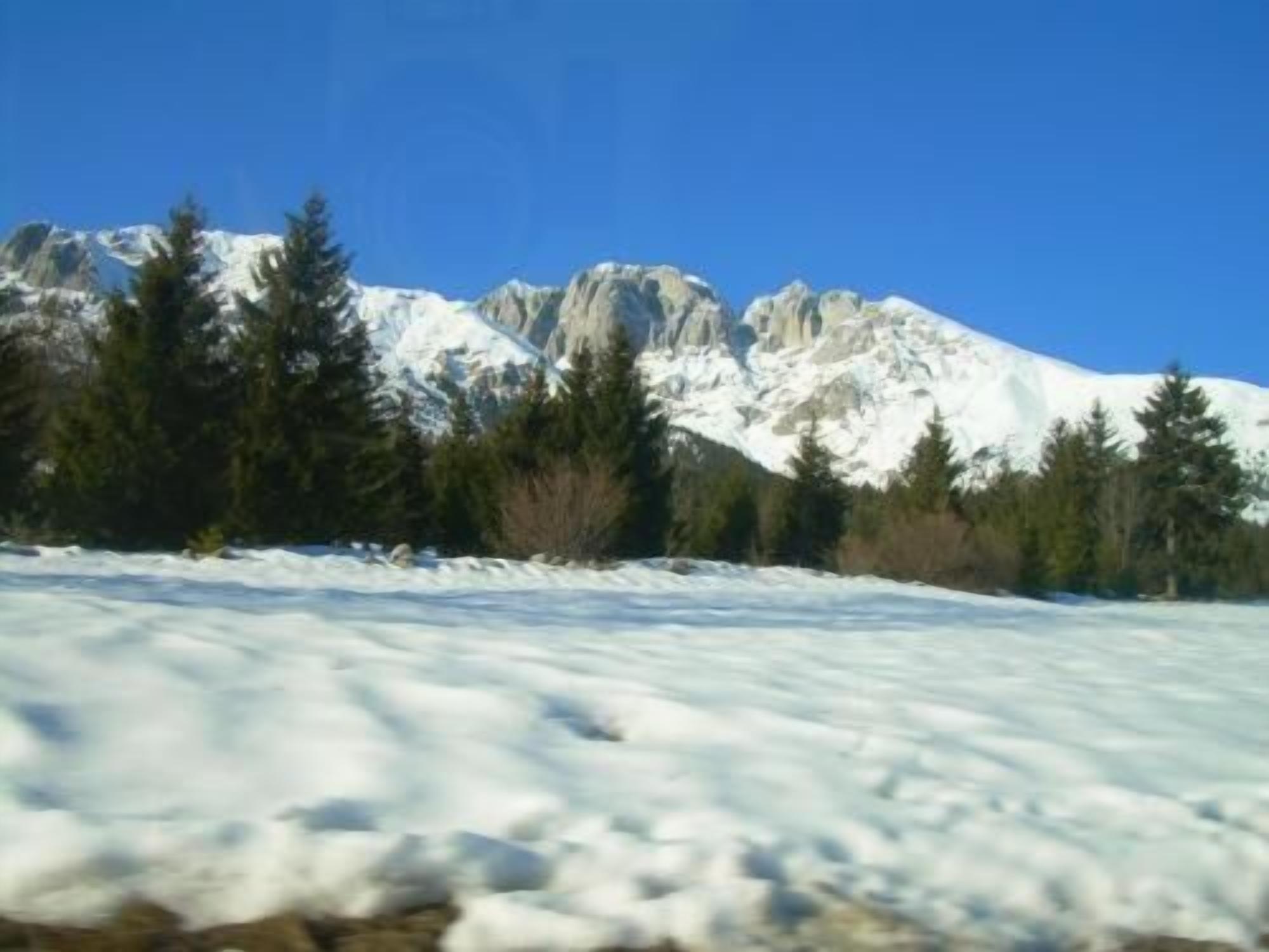A snowy mountain landscape with a clear sky.