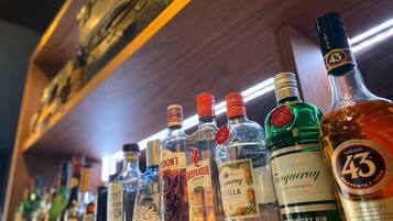 A variety of liquor bottles on a shelf.