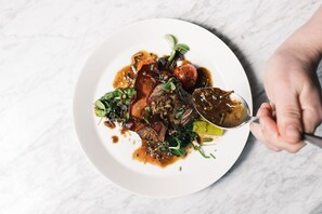 A plate of food with a spoon. - Alex Maastricht (Maastricht)