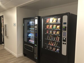 Two vending machines in a hallway with a sign that reads "VENDORS". - Extended Stay America Select Suites - Charlotte - Northlake (Charlotte)