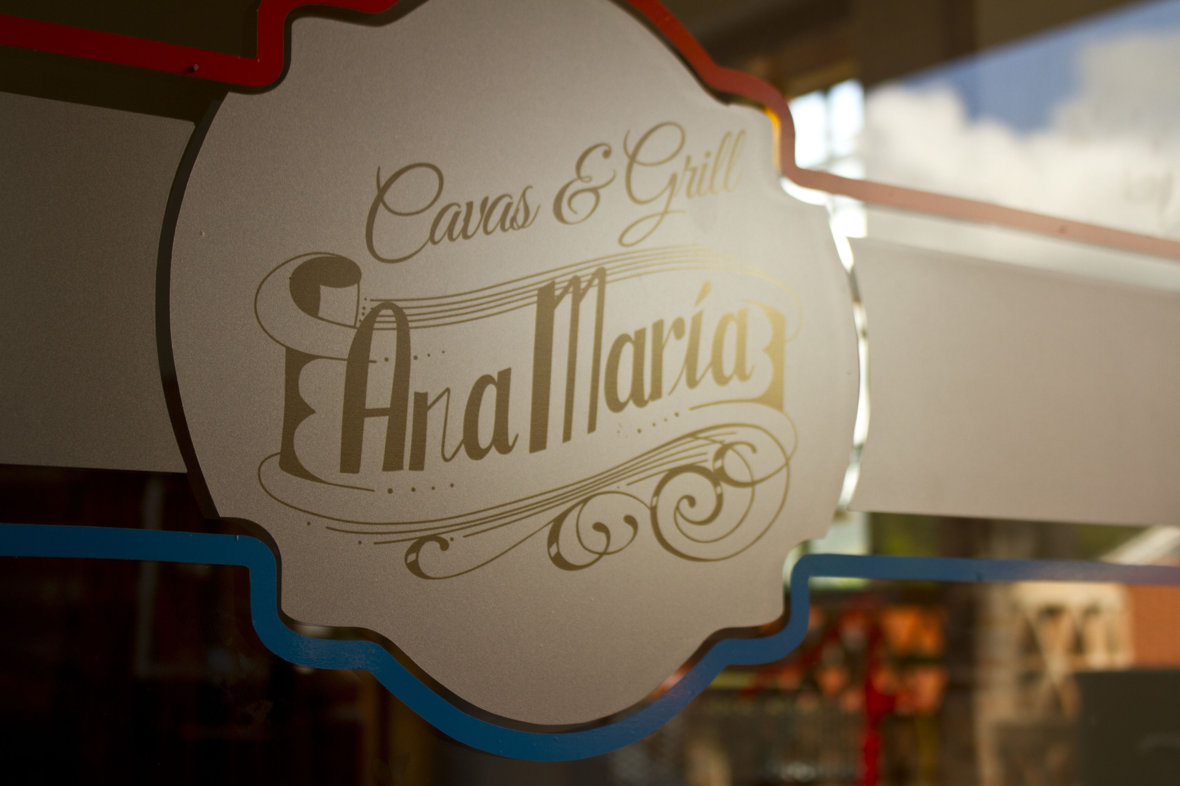 A sign with the text "Cavas & Grill" and "Anamaria" on it.