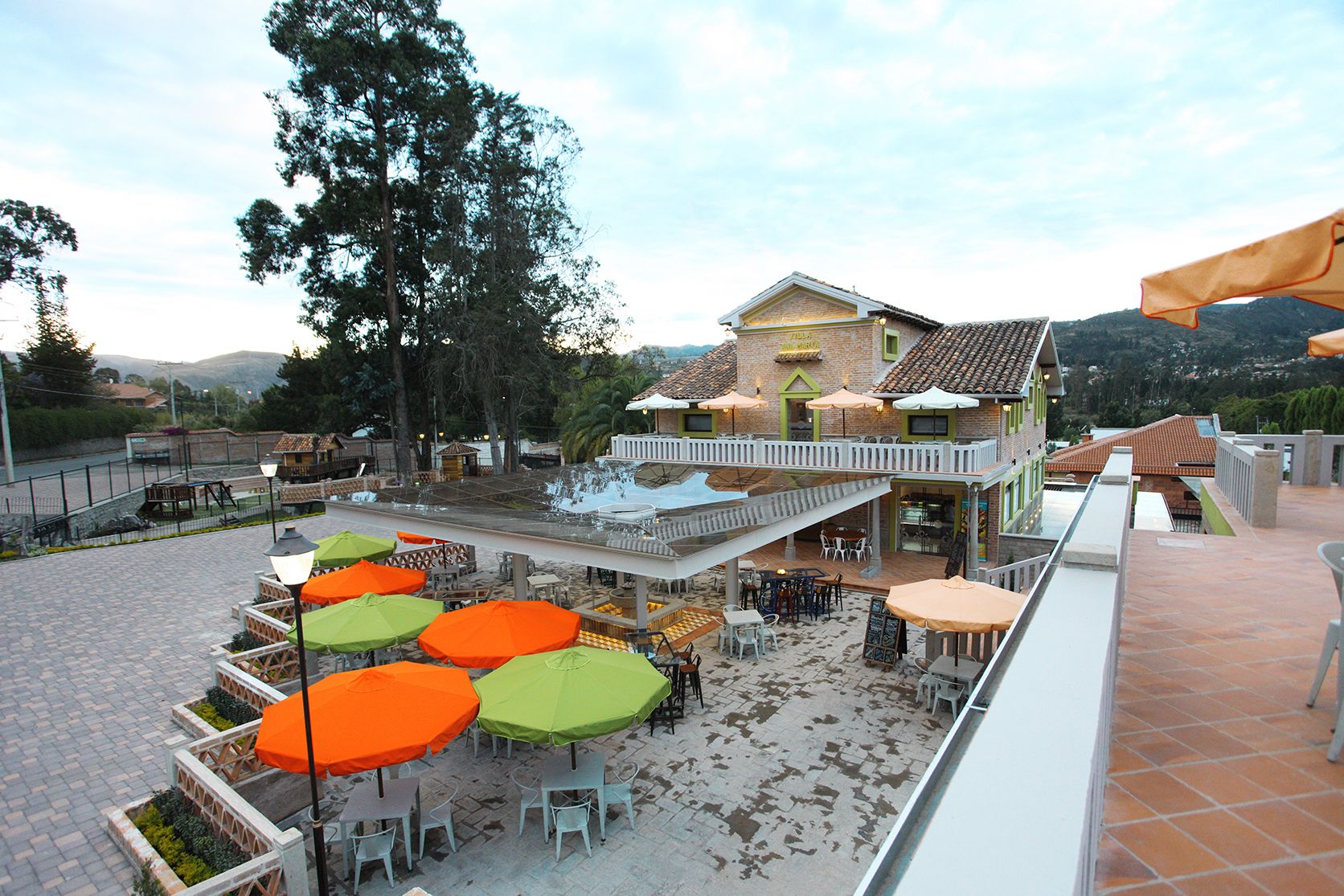 Una terraza en la azotea con mobiliario exterior y vistas del paisaje circundante.