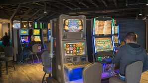 A casino with multiple slot machines and gaming tables. - The New Cavalier Inn (Winnipeg)