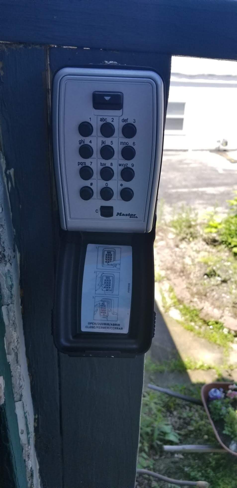 A keypad with a manual and a label indicating "OPEN/OUVRIR/ABRIR" and "CLOSE/FERMER/CERRAR".
