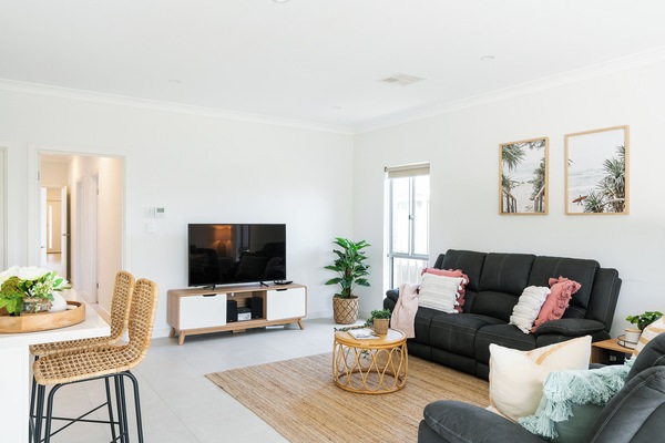 nviting living: Cozy sofa, modern TV—perfect for relaxation and entertainment.