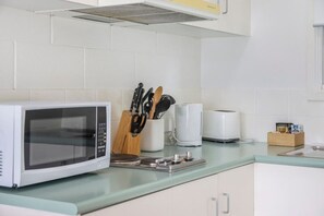 Fridge, microwave, stovetop, cookware/dishes/utensils