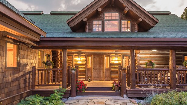 A log cabin with a porch, wooden exterior, and a stone pathway leading to the entrance. - Enchanting Private Mountain Sanctuary! Spectacular Views (Big Sky)