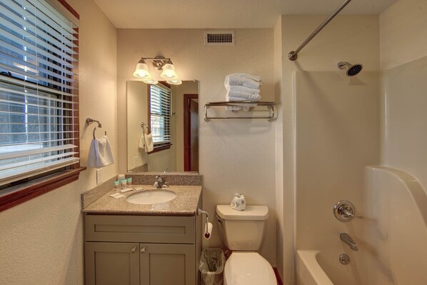 A bathroom with a sink, toilet, and shower. - Point Break Cottage- Steps to Beach- Community Pool & Spa (Buxton)