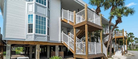 A two-story building with a balcony and a covered porch area.