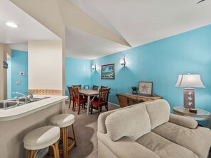 A compact living space with a kitchenette, dining area, and seating area.