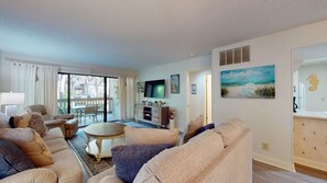 Relax in a well-appointed living room with a comfortable seating area and a large window offering a view of the outdoors.