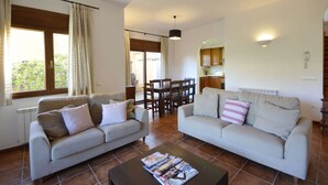 A living room with two sofas, a coffee table, and a dining area with a table and chairs. - Holiday rental semidetached with swimming pool in Begur, Centre (Begur)