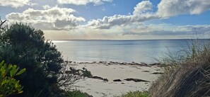 A beach with clear skies and a distant shoreline. - Secluded Coastal Retreat | 107 Acres + 7km Beach (Nepean Bay)