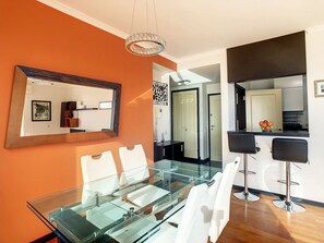 Enjoy meals in this stylish dining area with a glass-top table and comfortable seating.