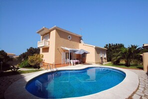 A two-story building with a swimming pool in front.