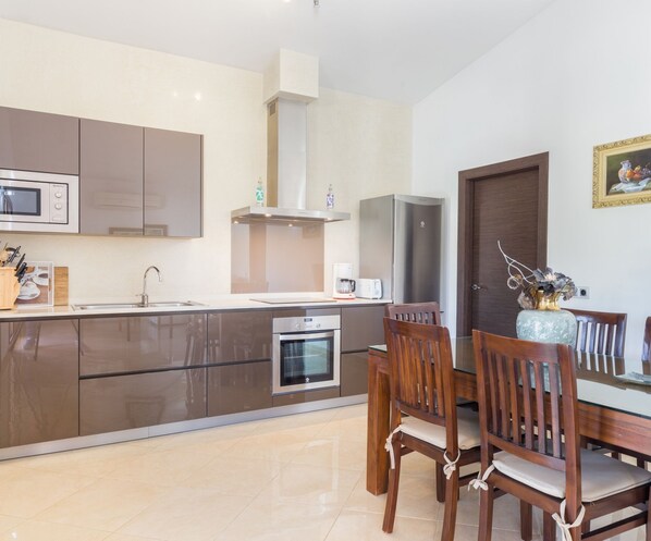 A modern kitchen with a dining area.