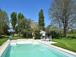 A backyard with a swimming pool, lounge chairs, and a small gazebo. - Beautiful authentic holiday home with pool (Chantenay-Saint-Imbert)
