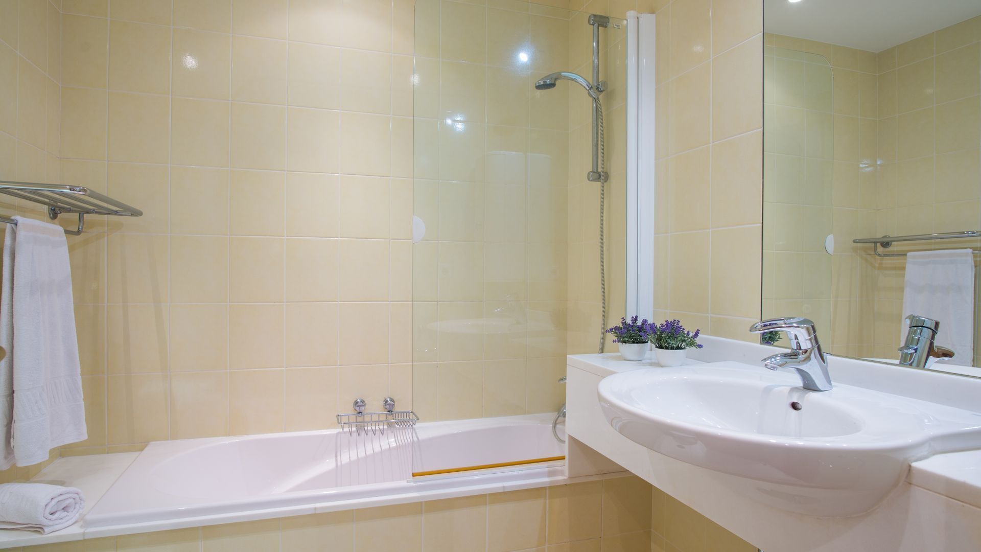 A bathroom with a bathtub, a sink, and a shower.
