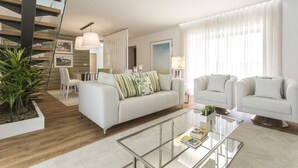 A modern living room with a glass coffee table, white sofas, and a staircase. - Gallo`s House, a place of excellence in the north of the country. (Várzea)