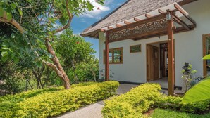A traditional building with a thatched roof, wooden pergola, and a pathway leading to the entrance. - Luxury villa close to Lovina with pool and staff and spectacular views! (Temukus/Lovina)