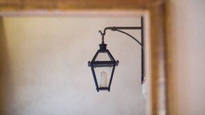 A wall-mounted lantern with a candle inside.