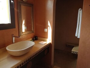 A bathroom with a large oval sink, a mirror, and a towel rack. - Beautiful Riad Asmaa near Agadir (10kms).  Large private pool. 5 bedrooms (Ibn Ayaden)