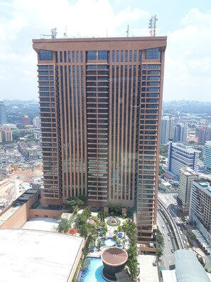 A high-rise building with a modern architectural design, featuring multiple floors and a prominent central entrance.
