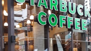 A Starbucks Coffee shop with outdoor seating and a visible Starbucks Card sign. - Cool Service Suites at Times Square (Kuala Lumpur)