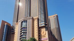 A tall, modern building with multiple floors and a prominent 'Times Square' sign. - Cool Service Suites at Times Square (Kuala Lumpur)