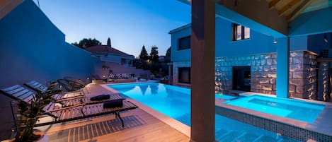 Outdoor pool, a heated pool, sun loungers