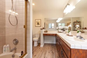 Bedroom 1 bathroom with double sinks and tub