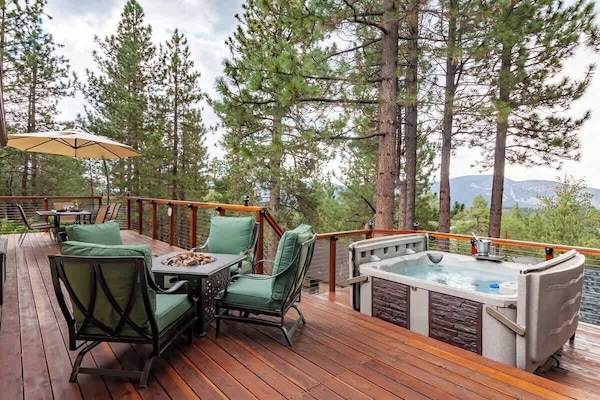 Treetop deck with hot tub and mountain views