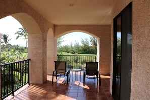 Relax in this serene outdoor space with a patio, perfect for dining or unwinding amidst lush greenery.