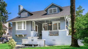 A two-story house with a covered porch, a small front yard, and a mailbox. - Relaxed Studio | Festivals & Fun Nearby (New Orleans)