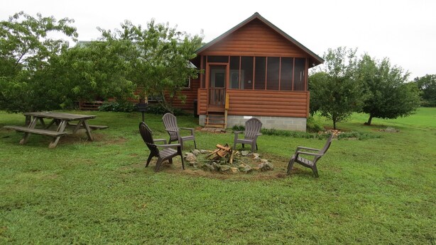A rustic cabin with a fire pit and outdoor seating. - SUNDANCER CABIN CADDO RIVER!!!!!   GREAT GETAWAY !!!!!!!! River Access!! (Glenwood)