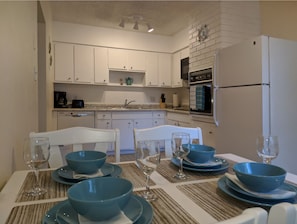 Enjoy meals in this kitchen with an oven, granite countertop, and dining table.