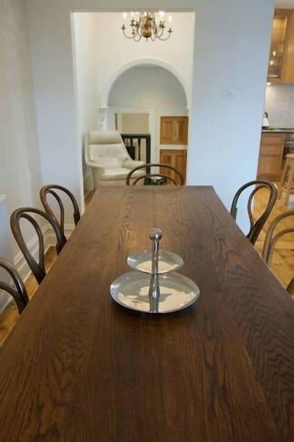 A dining table with a centerpiece, surrounded by chairs.