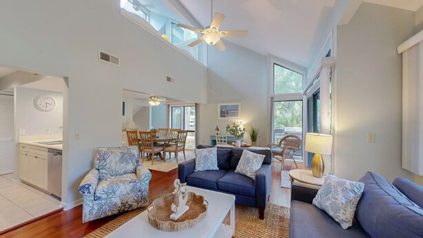 A spacious living area with a high ceiling, a dining table, and a sofa set. - Perfect Location for a Family Vacation! (Hilton Head)