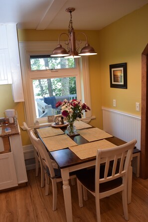 Enjoy meals in this dining area with a table for four, surrounded by a beautiful view.
