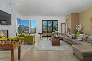 Smart TV, fireplace, table football, books
