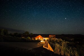 A starry night sky with a house and a sign labeled "S5" in a rural setting. - Rusty Guest House: Solitude at Zion National Park. (Virgin)