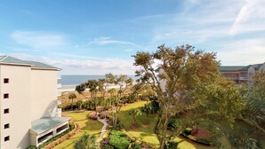 A resort with a view of the beach, a well-maintained lawn, and a building with a flat roof. - Top floor vacation rental - expansive ocean views and steps from the beach! (Hilton Head)