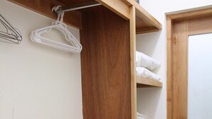 Une armoire en bois dotée de plusieurs étagères et de tiroirs, ainsi que d’un panier et d’une porte avec une poignée.
